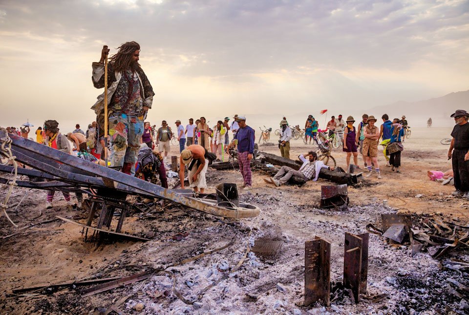Remains of the Man 2013 -  Burning Man arts festival participant Kaspian Khalafi stands atop the